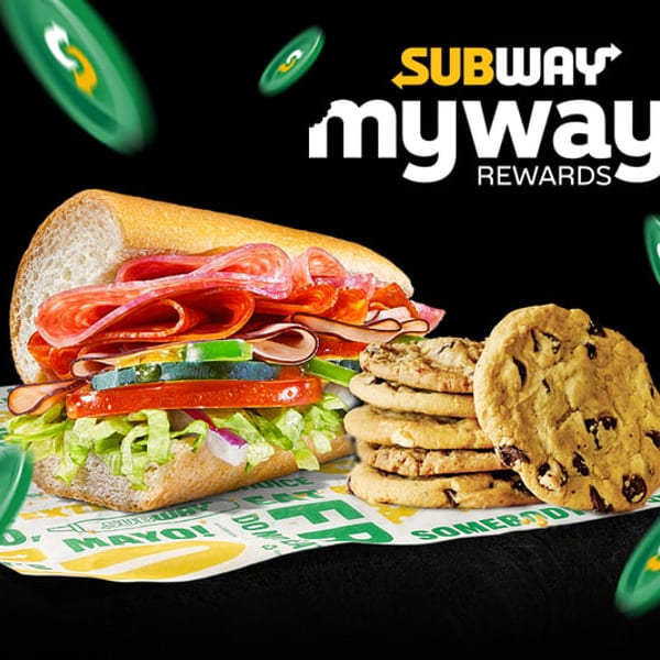 Subway sandwich with cookies on branded paper, with "Subway MyWay Rewards" text and green tokens.